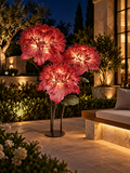 Giant Chrysanthemum Trio outdoor illuminated flower lamp at night, illustrative setting